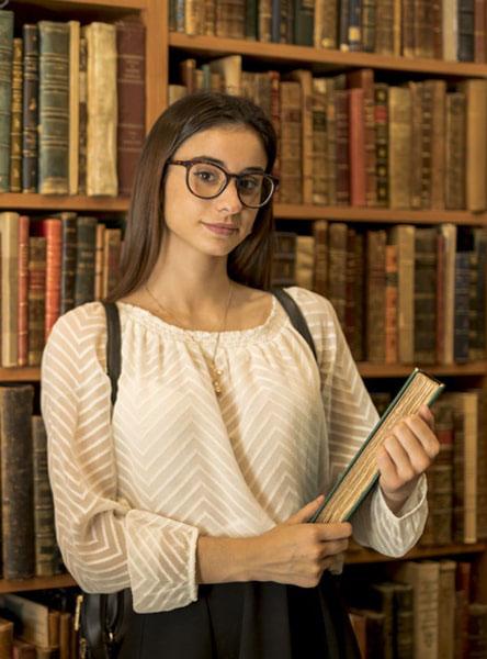 Girl searching library for books related computer education