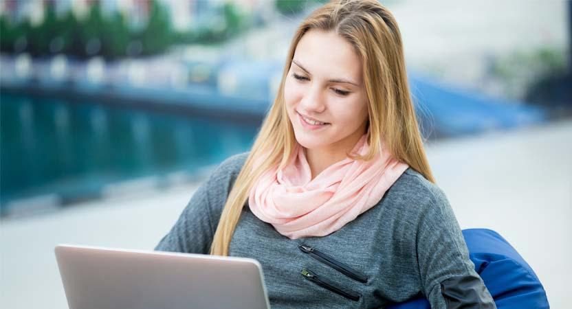 The young girl is exploring internet to learn about how to create mark-sheet in MS Excel.