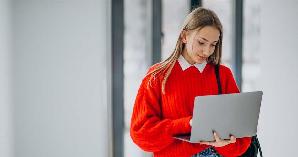 Girl searching about ASP .NET in laptop hile going somewhere 