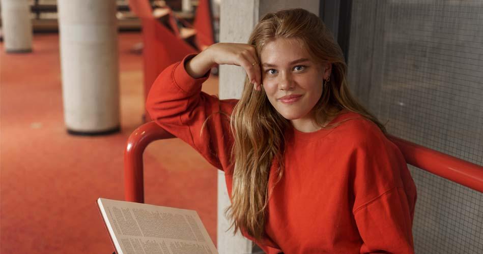 Girl reading book of Diploma in CADD Engineering