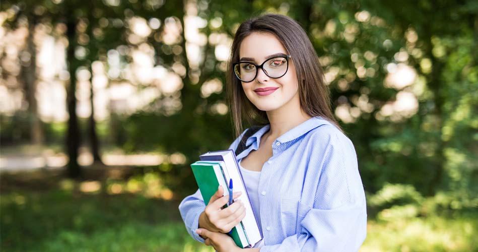 Girl with books about Diploma In System Software Development