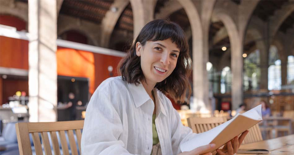 Girl learning through books about Java I/O course