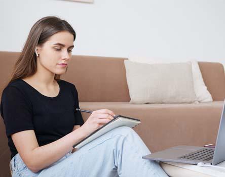 Girl revising her notes on Restful Web Services 