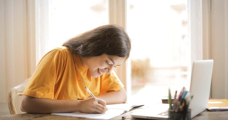 Girl taking notes on Restful Web Services through online 