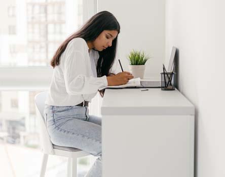 Girl making notes on Spring Cloud course