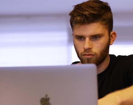 Boy working on PC for Surveyor & Work Assistant course