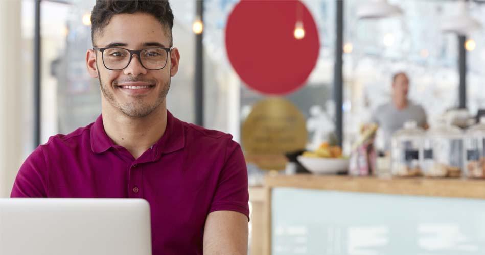 Boy working at cafe on laptop regardibg Surveyor & Work Assistant