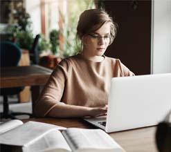 The girl is browsing for angular class on her laptop.